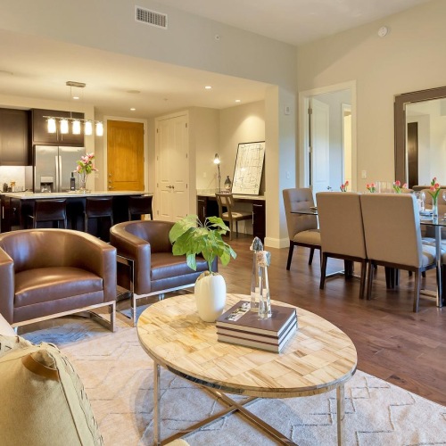 Wide open living areas flooded with natural light a living room with a dining table and chairs