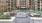 a courtyard with a fountain and buildings in the background